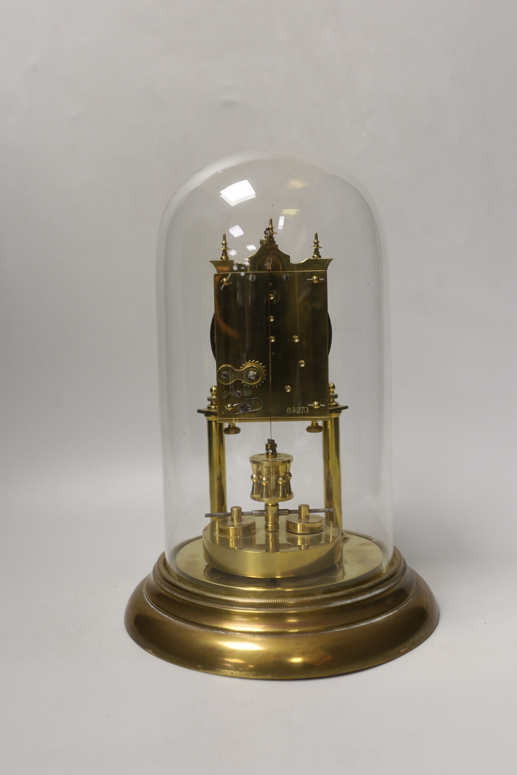 An early 20th century clock under glass dome, 29cm